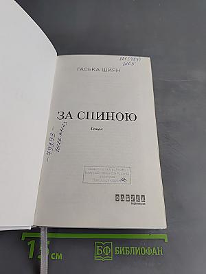 За спиною